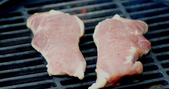 Delicious Striploin Steaks Grilled on Fire with Smoke.