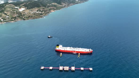 Tugs help the gas tanker to go to sea aerial view 4 K Turkey Alanya