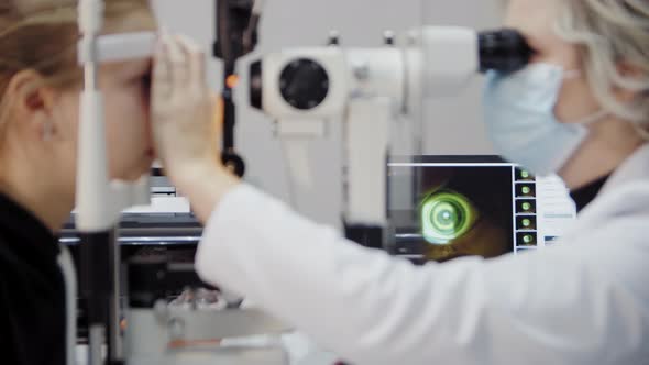 The Ophthalmologist Examines the Patient's Eye and Then Looks Into the Camera