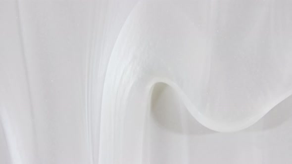 White Cosmetic Gel Fluid with Flowing Down on a White Surface