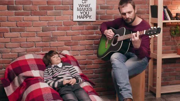 Father Playing Guitar with His Son