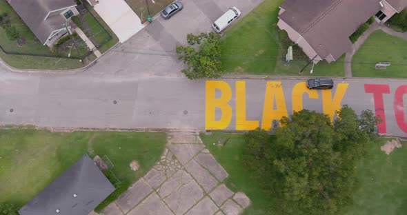 Bird eye view of a large "Black Towns Matter" sign painted on street in Houston Historical independe