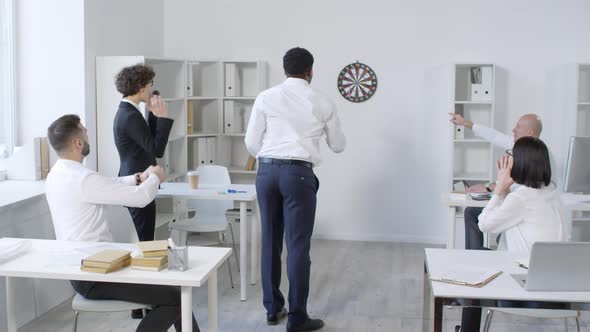 Afro-American Office Worker Throwing Darts