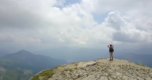 Aerial drone view of a woman hiking in the mountains