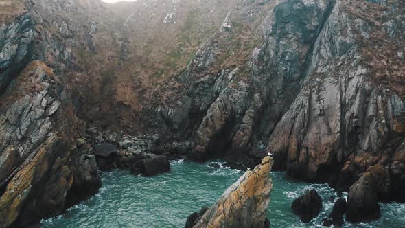 The beautiful cliffs of Howth in Ireland. This was a foggy day with small waves. The water had a ver