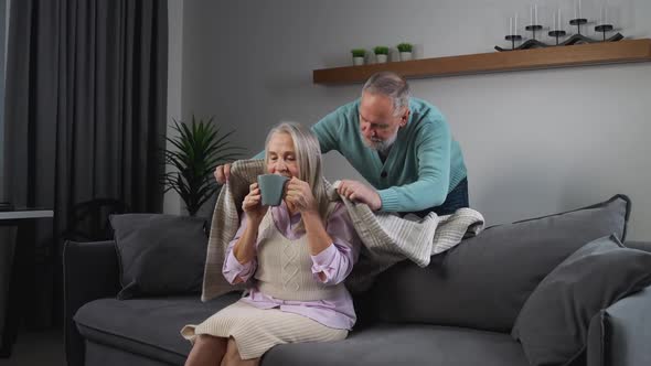 Elderly Grayhaired Man Covers His Wife with a Blanket Taking Care of Their Loved Ones Adult People