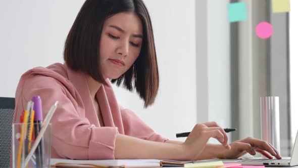 Young Asian business  woman  in office face portrait stress.