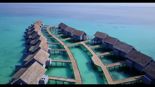 Aerial drone shot nature of tranquil lagoon beach adventure by blue green ocean and bright sandy bac