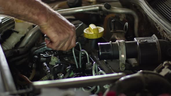 Auto Mechanic Fixing The Pipes Of The Faulty Vehicle Engine Fuel System In The Repair Shop With A D