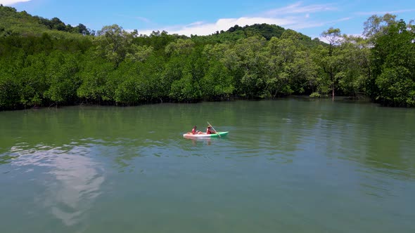 Couple in Kayak in the Ocean of Phuket Thailand Men and Woman in Kayak at a Tropical Island with