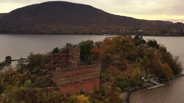aerial drone camera flight towards Bannerman's Castle in the Hudson River in Beacon, NY. It's a clou