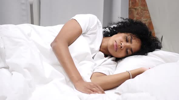 Uncomfortable AfroAmerican Woman Sleeping on Side in Bed at Night Restlessness