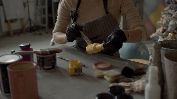 The Artist Paints the Bottle Yellow