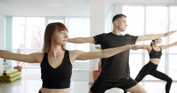 Happy Diverse Group of Young People Practicing Yoga Poses Together