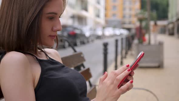 Cute Girl Use Red Smartphone Outdoor