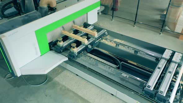 Factory Mechanism Is Processing Wooden Bars