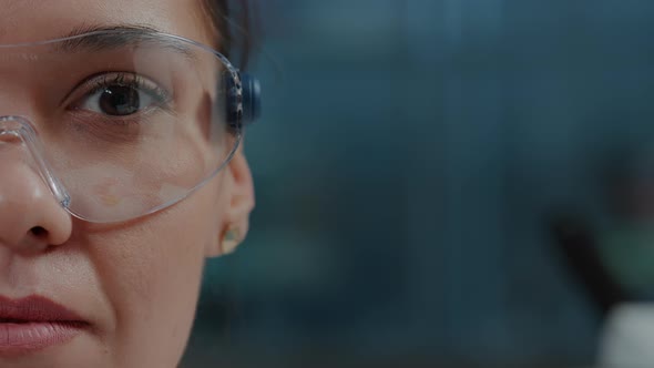 Woman Scientist Wearing Protective Glasses with Virtual Reality