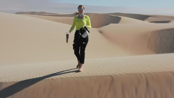 Confident Beautiful Woman in Black Neon Futuristic Costume and VR Headset Desert