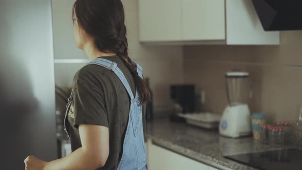 Woman taking fruit from fridge