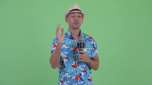 Happy Multi Ethnic Tourist Man As Host with Microphone