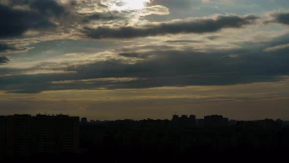 Time Lapse of Cloudy Sunset with City in the Background