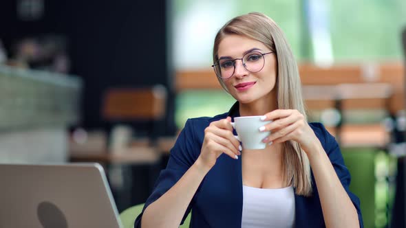 Happy Beautiful Young Businesswoman Relaxing Drinking Coffee at Restaurant Posing Looking at Camera