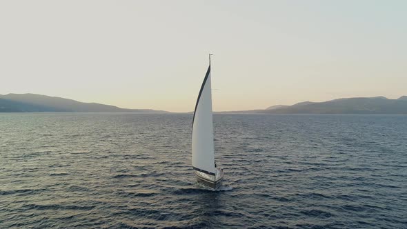 Aerial view of a sailboat anchored in the mediterranean sea, Vathi, Greece.