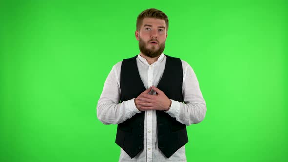 Man Listens To Information Looking at Camera, Is Shocked and Very Upset. Green Screen