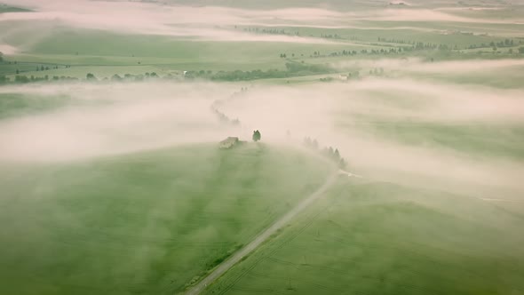 Flying over the foggy Tuscany Italy landscape