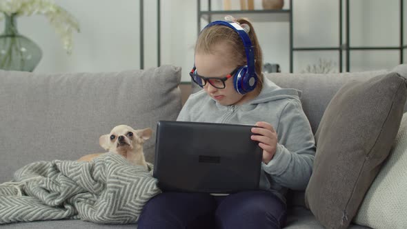 Special Need Child with Dog Watching Cartoons Online