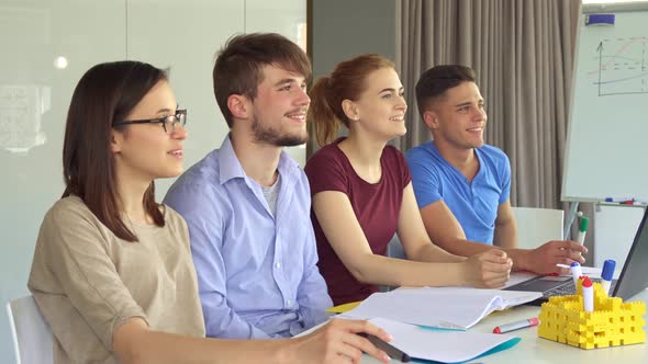 Young Managers Watch Something Together at the Office