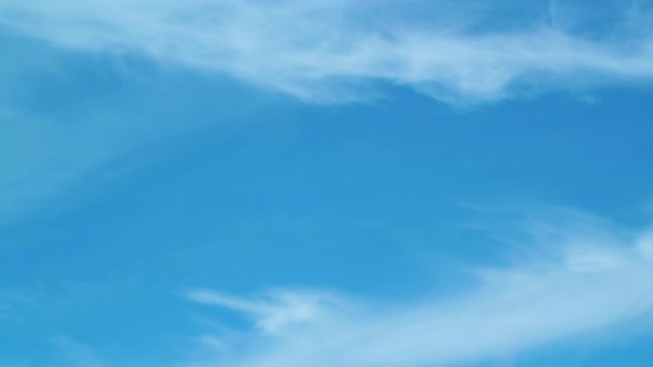 Moving cloud time lapse at clear weather on blue sky, medium shot alt