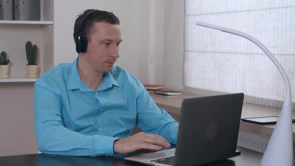 Portrait Men Surfing Internet on Laptop Indoors