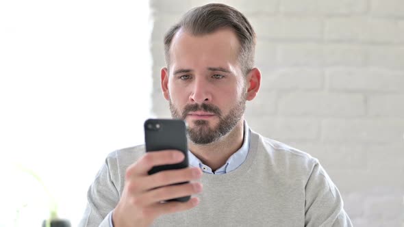 Portrait of Attractive Young Architect Using Smartphone