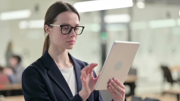 Portrait of Young Businesswoman using Tablet in Office