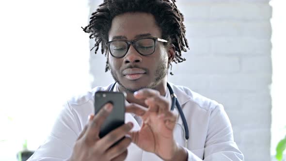 Portrait of African Doctor Using Smartphone