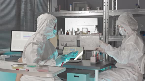 Female Scientists in Hazmat Suits Working
