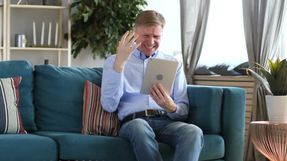 Middle Aged Man Using Tablet Reacting to Financial Loss