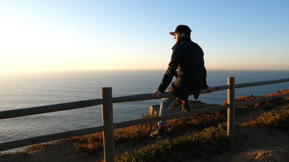 Cabo da roca. Man sitting and looking at Atlantic ocean