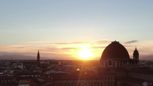 Flying at sunset over Florence city in Tuscany, Italy