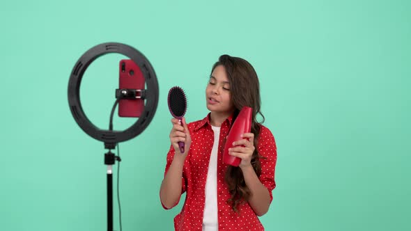 Smiling Kid Beauty Blogger Present Shampoo Against Hair Loss Showing Comb Product Proposal