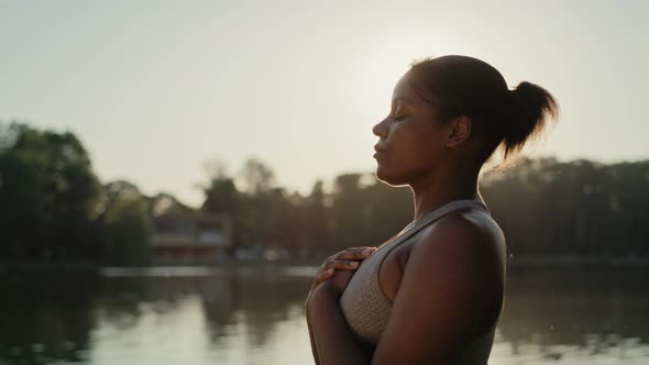 African American woman practicing breathing exercise at the park. Shot with RED helium camera in 8K.