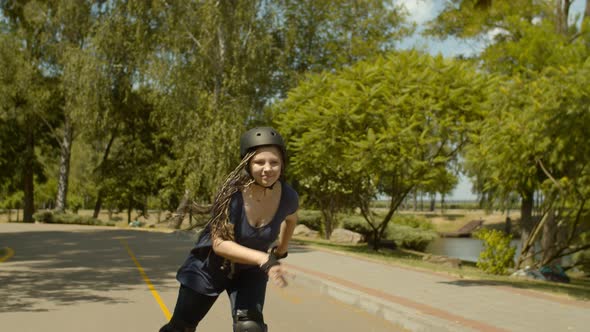 Active Young Female Rollerblading at Speed in Park