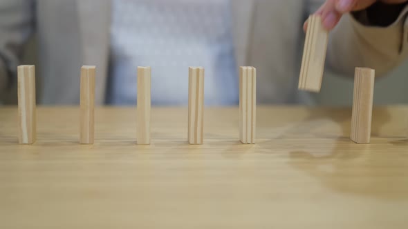 Woman Places Blocks in a Row After Falling