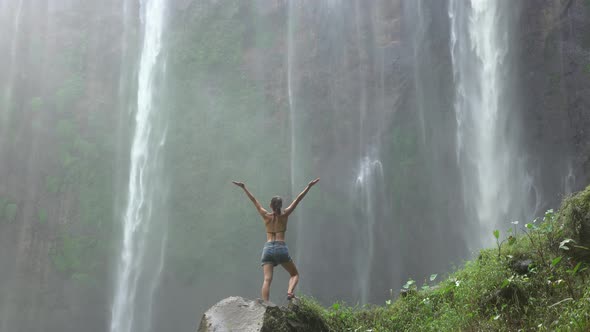 Woman near beautiful jungle waterfalls