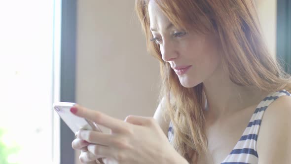 Woman video chatting on smartphone