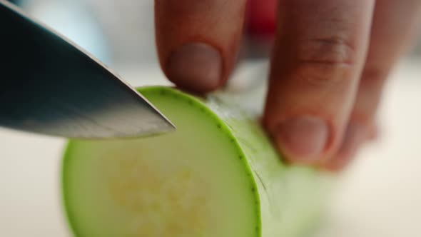 Close-up: The chef cuts the zucchini finely with a knife