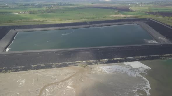 Aerial Video of an Ash Dump. The Pipeline From Which the Products of Coal Combustion Are Discharged