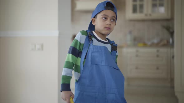 Portrait of an African American Boy in a in Blue Uniform Looking Into the Camera