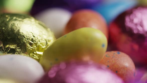 Rotating shot of colorful Easter candies on a bed of easter grass